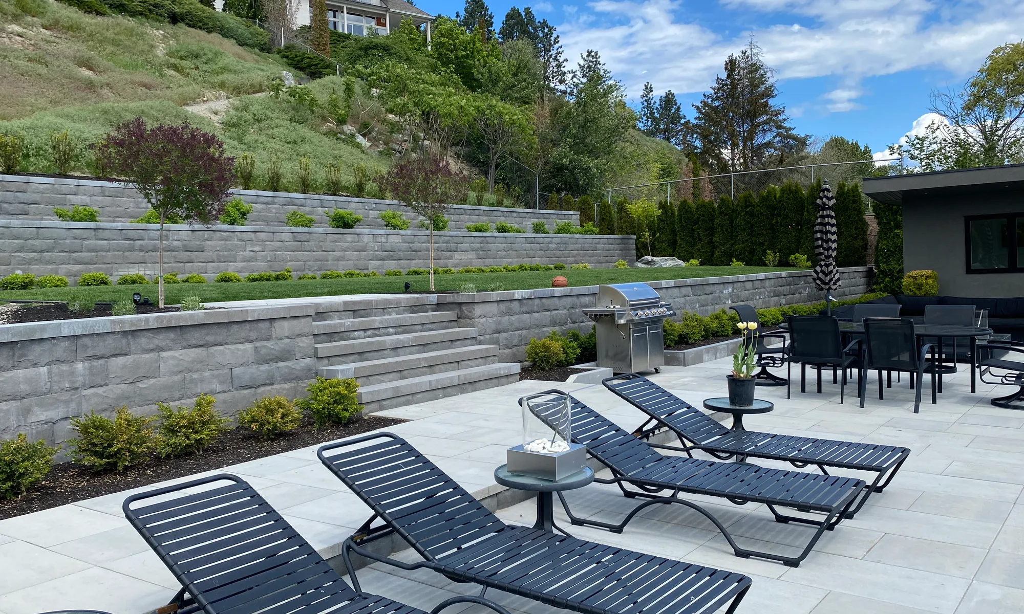 chairs and retaining wall fixture with paver stone flooring