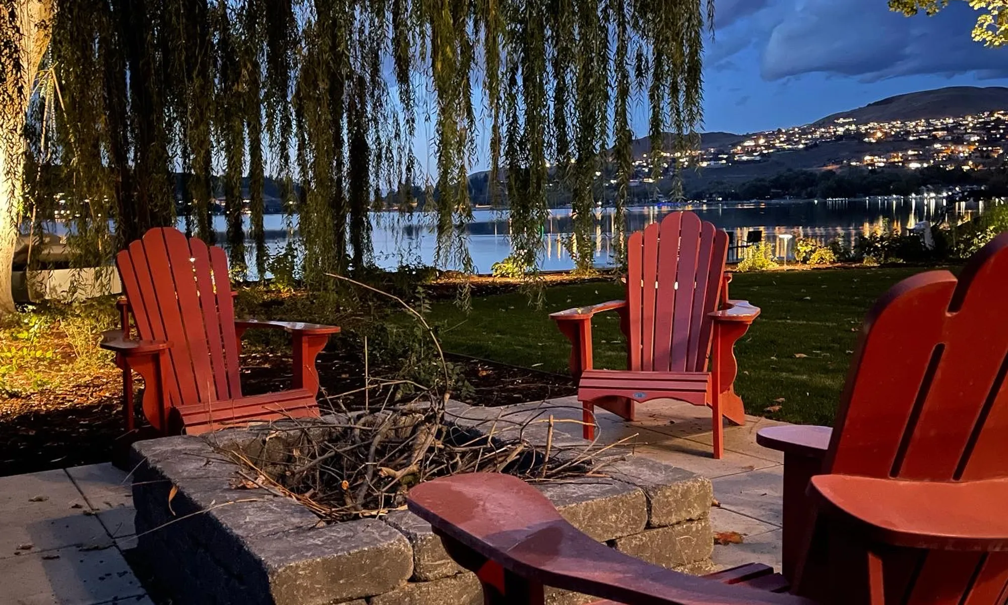 fire place with red chairs lake front