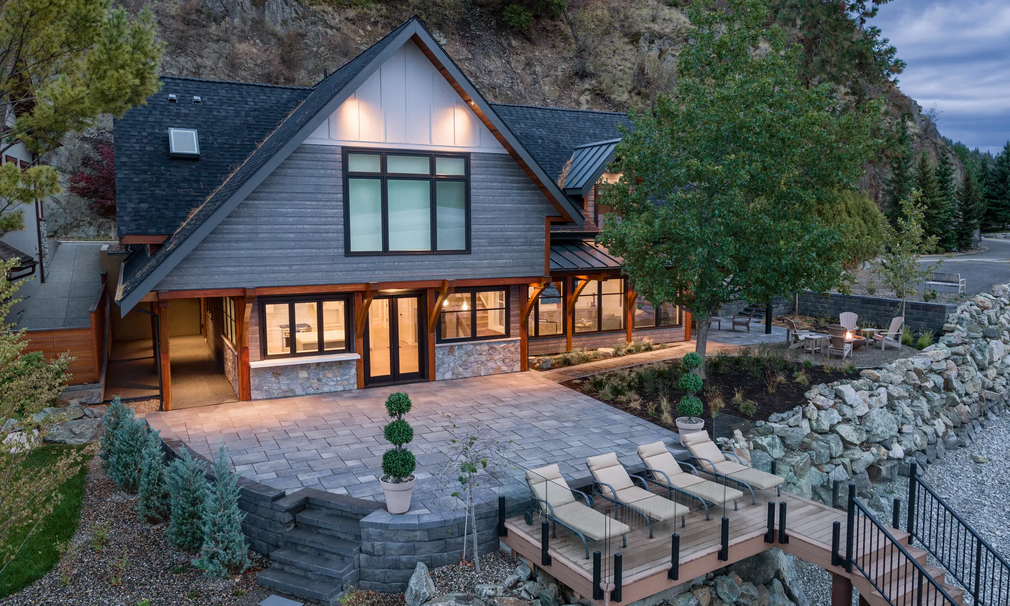 lake front home with stairs and shrubs
