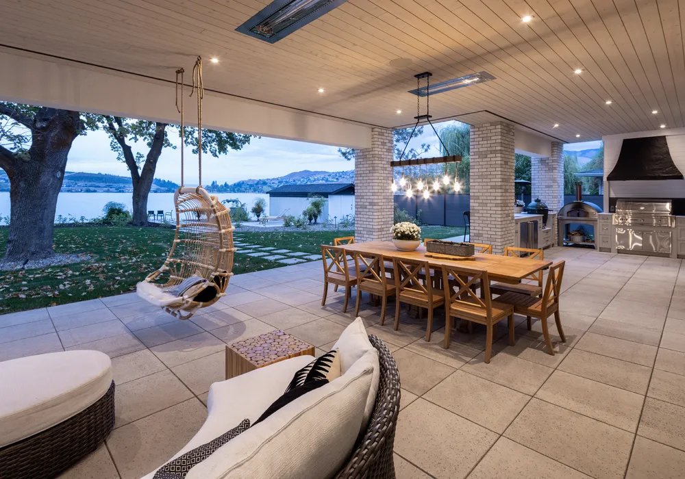 lake front home with outdoor lighting an paver stones