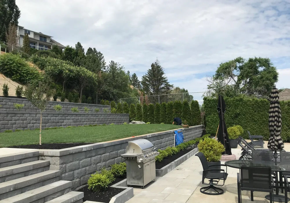worker working with bbq retaining wall and steps