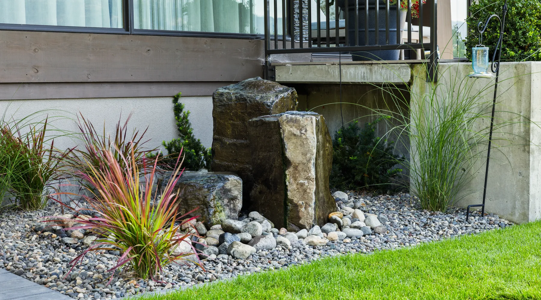 modern home water feature with green grass