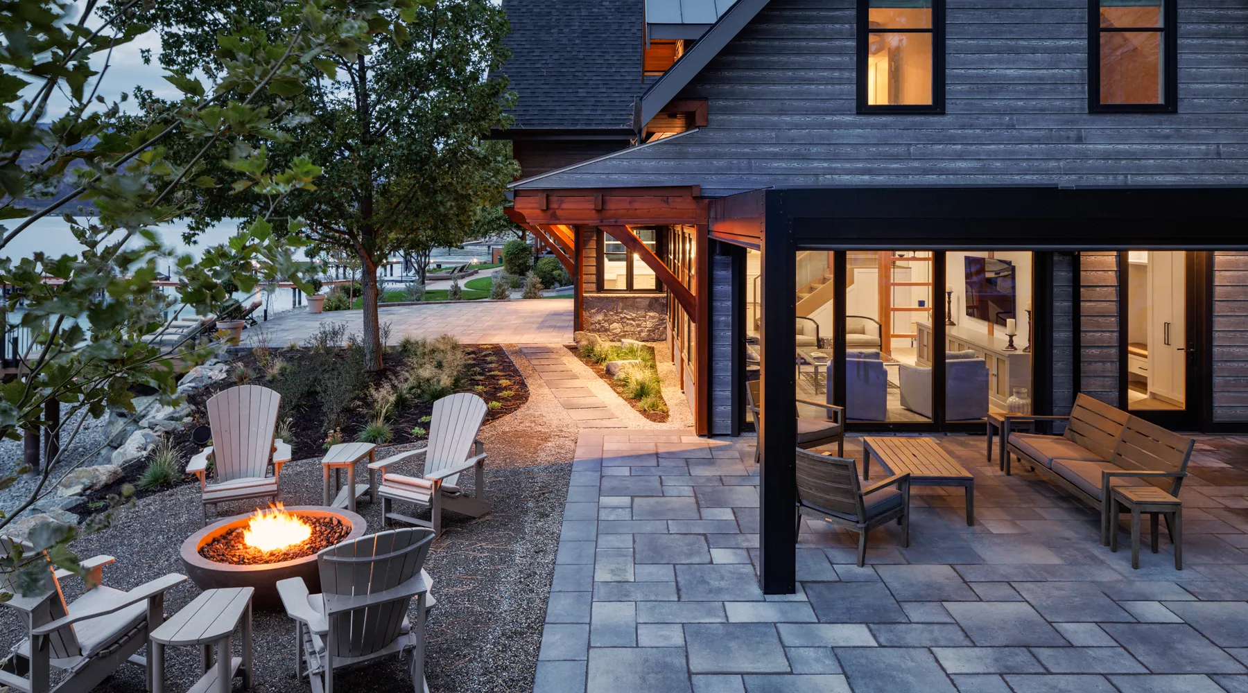 modern home with firepit walkway and stoned seating area