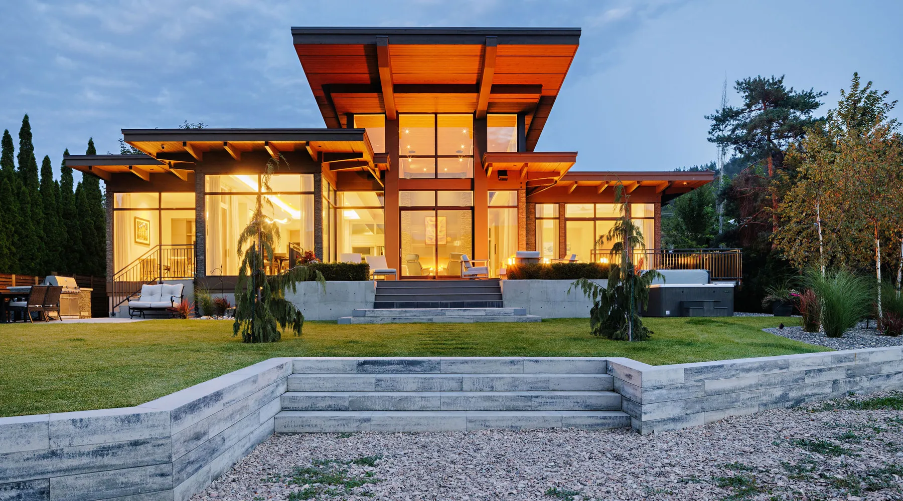 modern home with lawn retaining wall and stairs